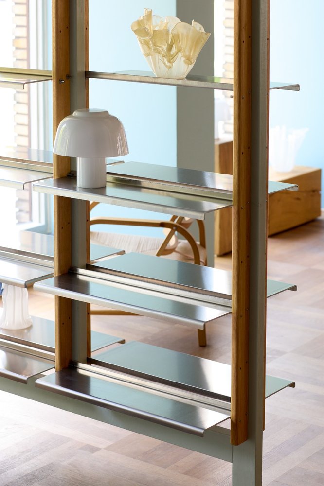 YUKI Lamp Olive on a MOD Shelving System shelf in front of a light blue wall
