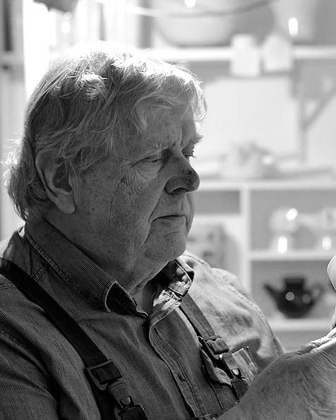 Snorre Læssøe Stephensen examining a ceramic piece in his studio