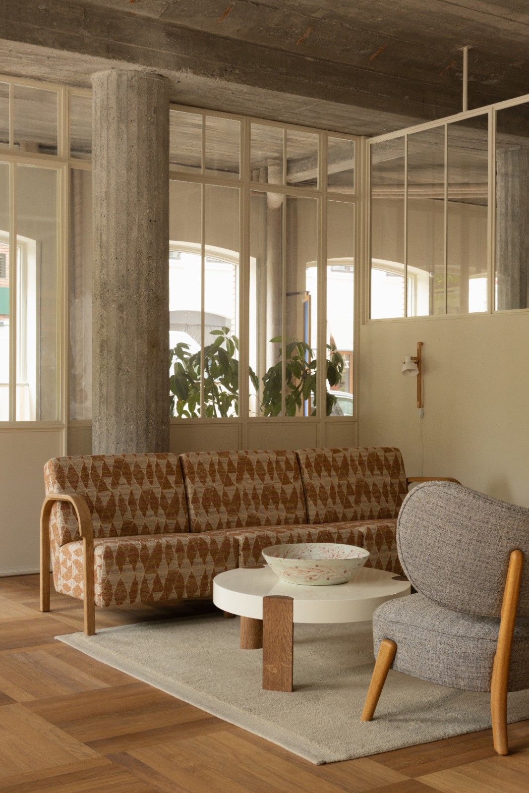 ARCH 3 Seater Sofa in orange patterned upholstery in a concrete-pillared living room