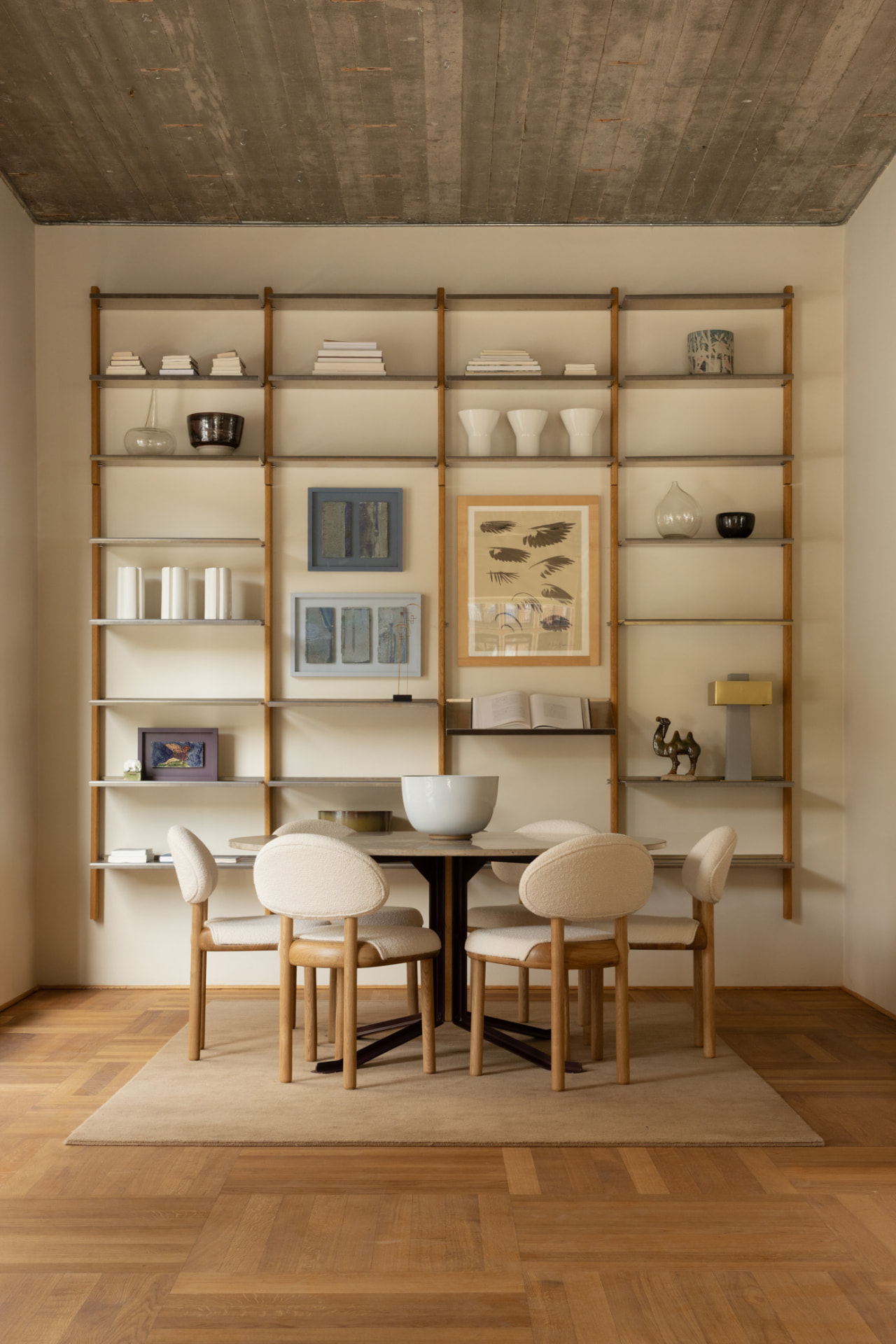 MOD chairs and a FER table styled in Mazo’s Copenhagen showroom, in front of a modular oak shelving wall