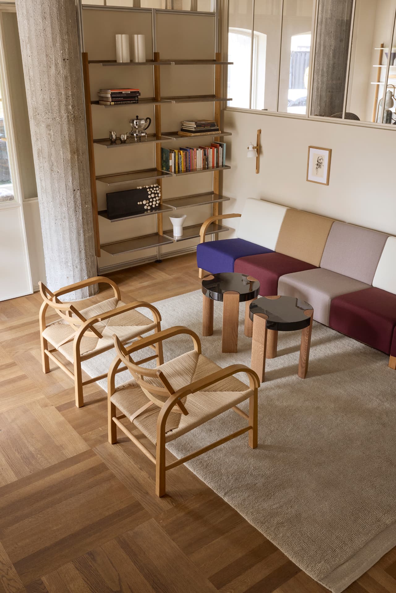 Two Arch Lounge Chairs with the colour-block TMBO Sofa and MOD Shelving System in the Mazo showroom