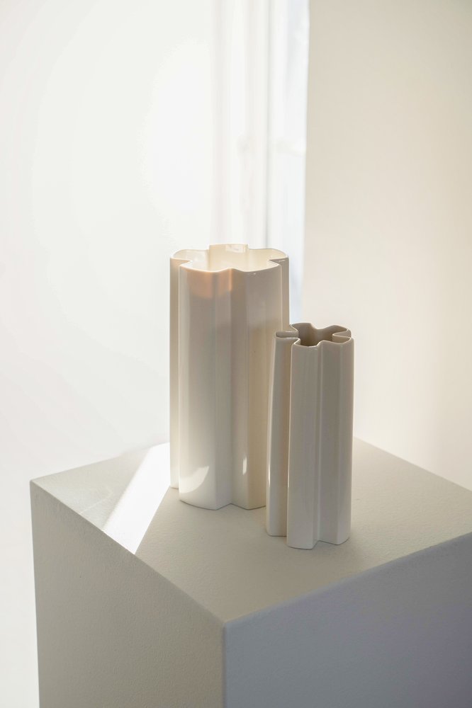 KYO Star Vases in white porcelain on a plinth beside a bright window