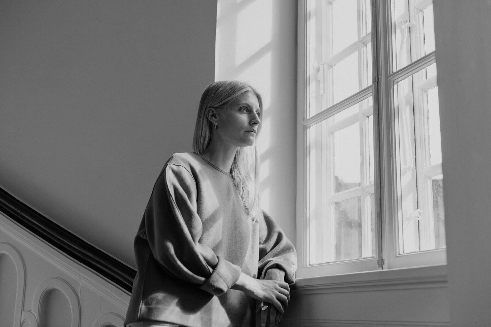 The YUKI lamp designer photographed in black and white by a window