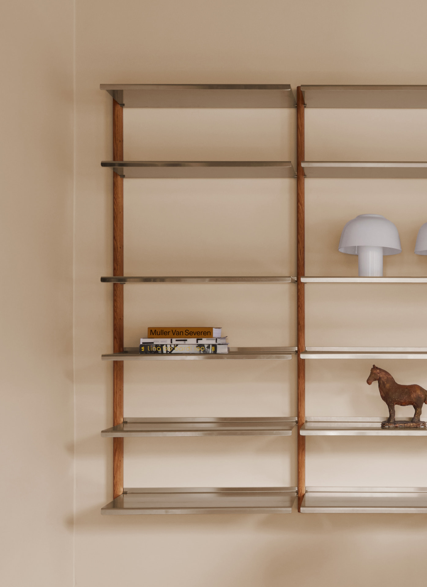MOD Shelving System in oak and aluminium with a white mushroom lamp, books and a small horse sculpture