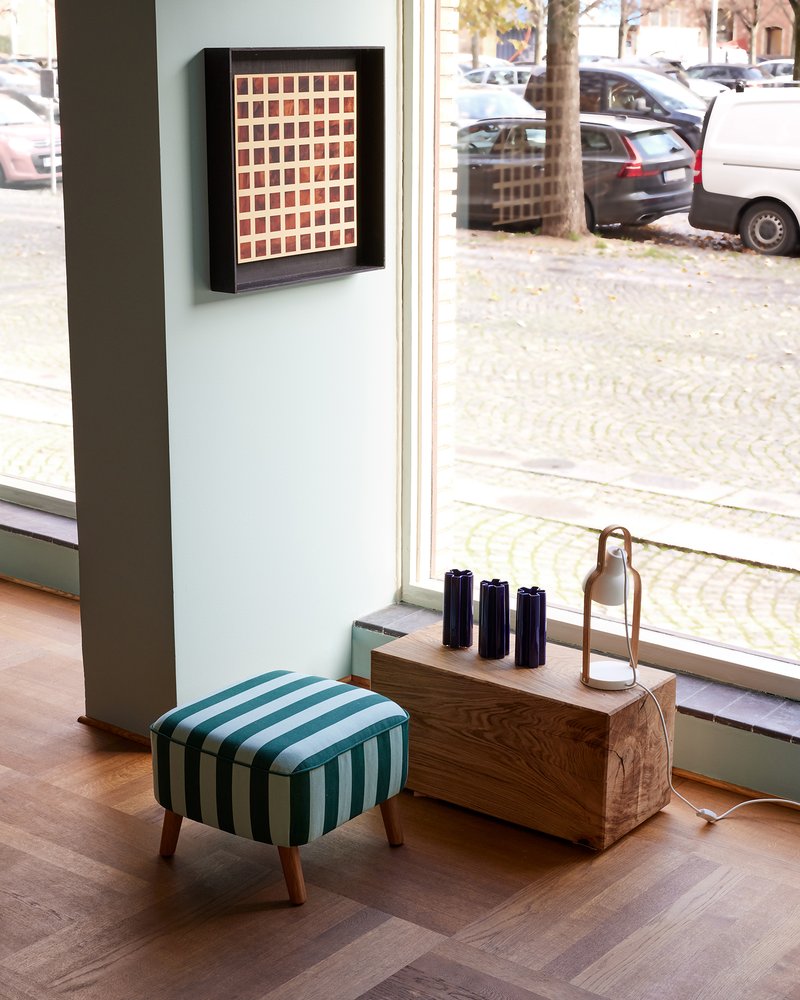 Blue KYO Star Vases styled on a wooden sideboard by a shop window