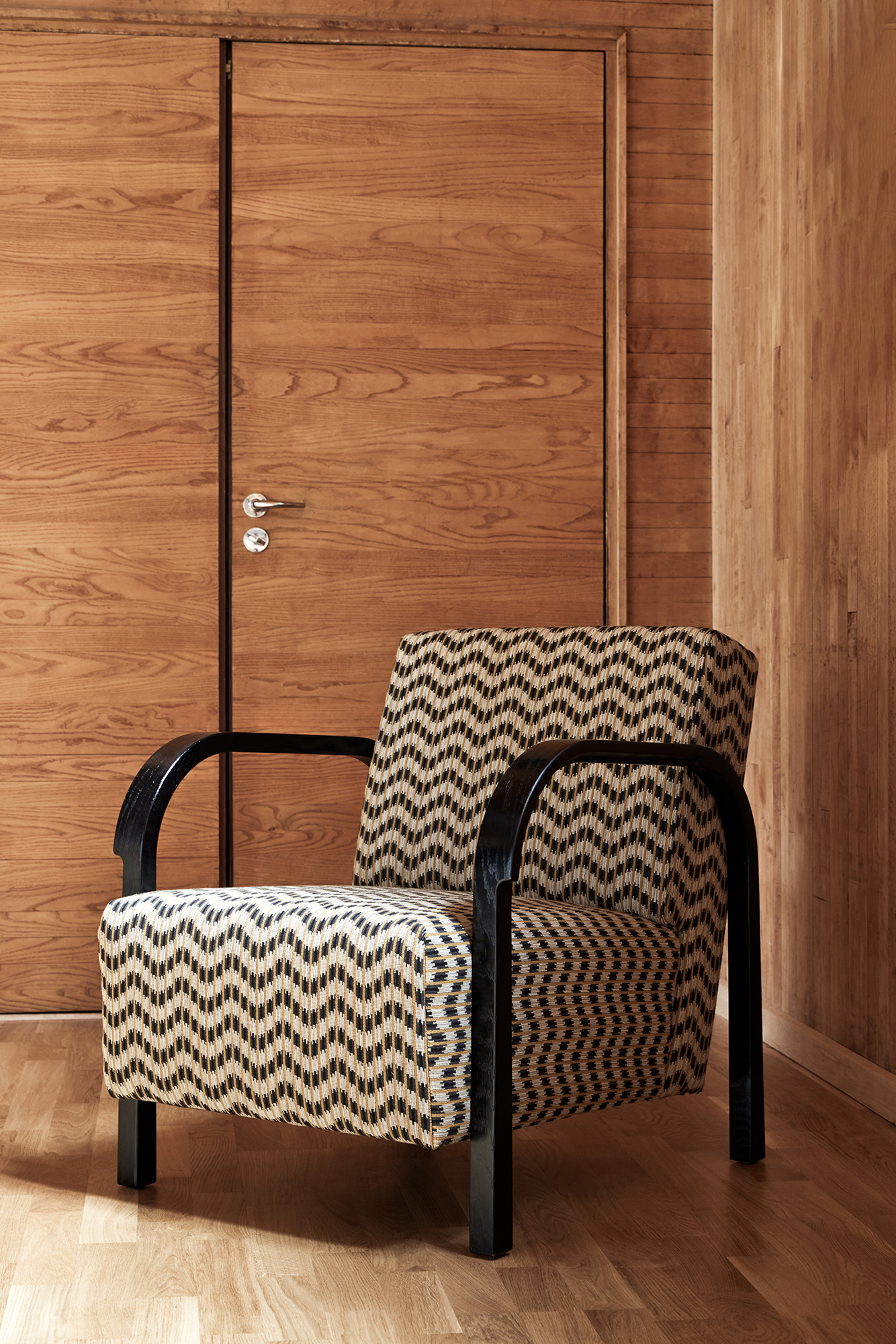 Arch Lounge Chair in patterned upholstery with a dark stained frame