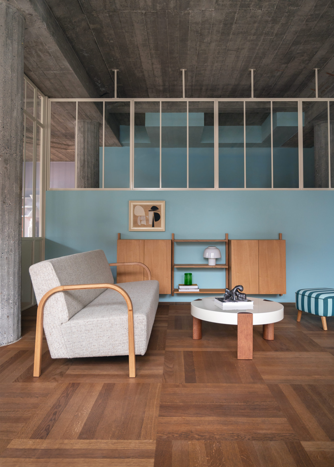 Grey ARCH 3 Seater Sofa with oak armrests against a light blue wall with MOD Shelving System