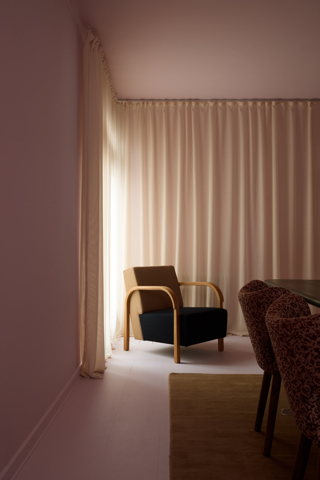 Arch Lounge Chair by sheer curtains in a soft pink room