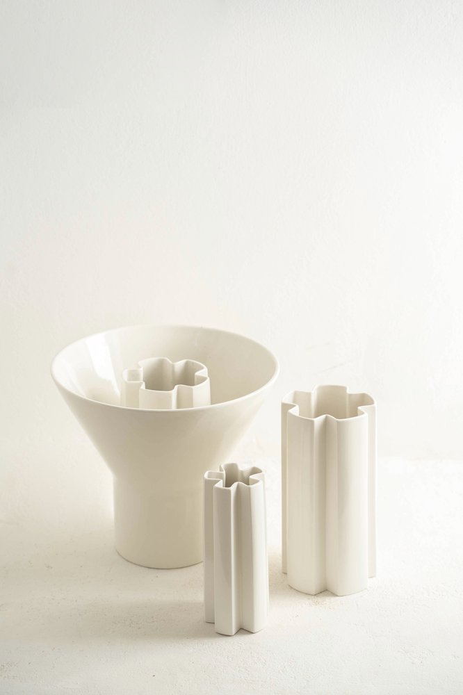 KYO Star Vases grouped with a white porcelain funnel vase