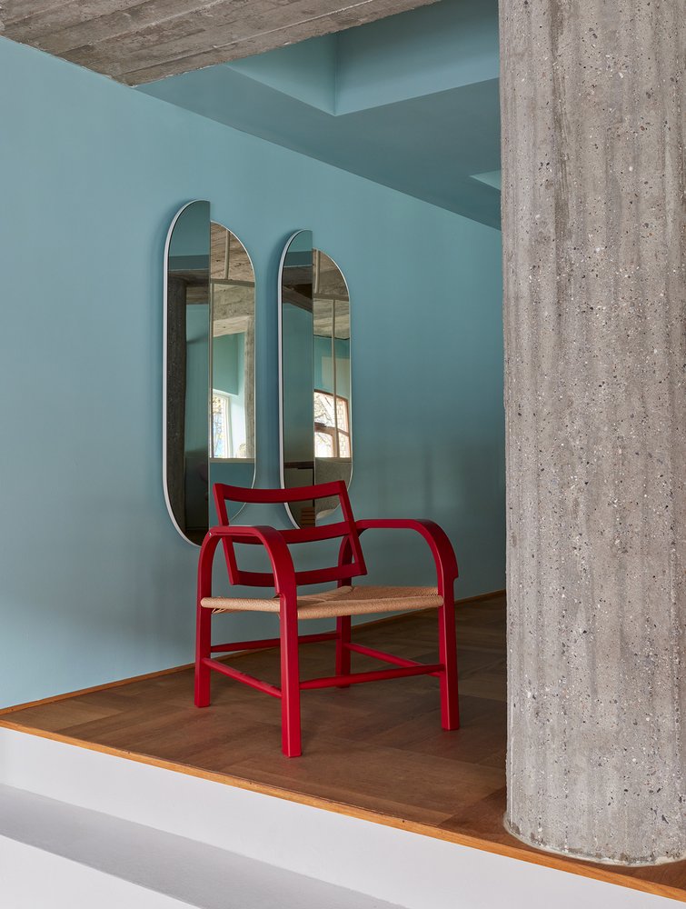 RAE Mirror Full Body pair on a blue wall behind a red armchair