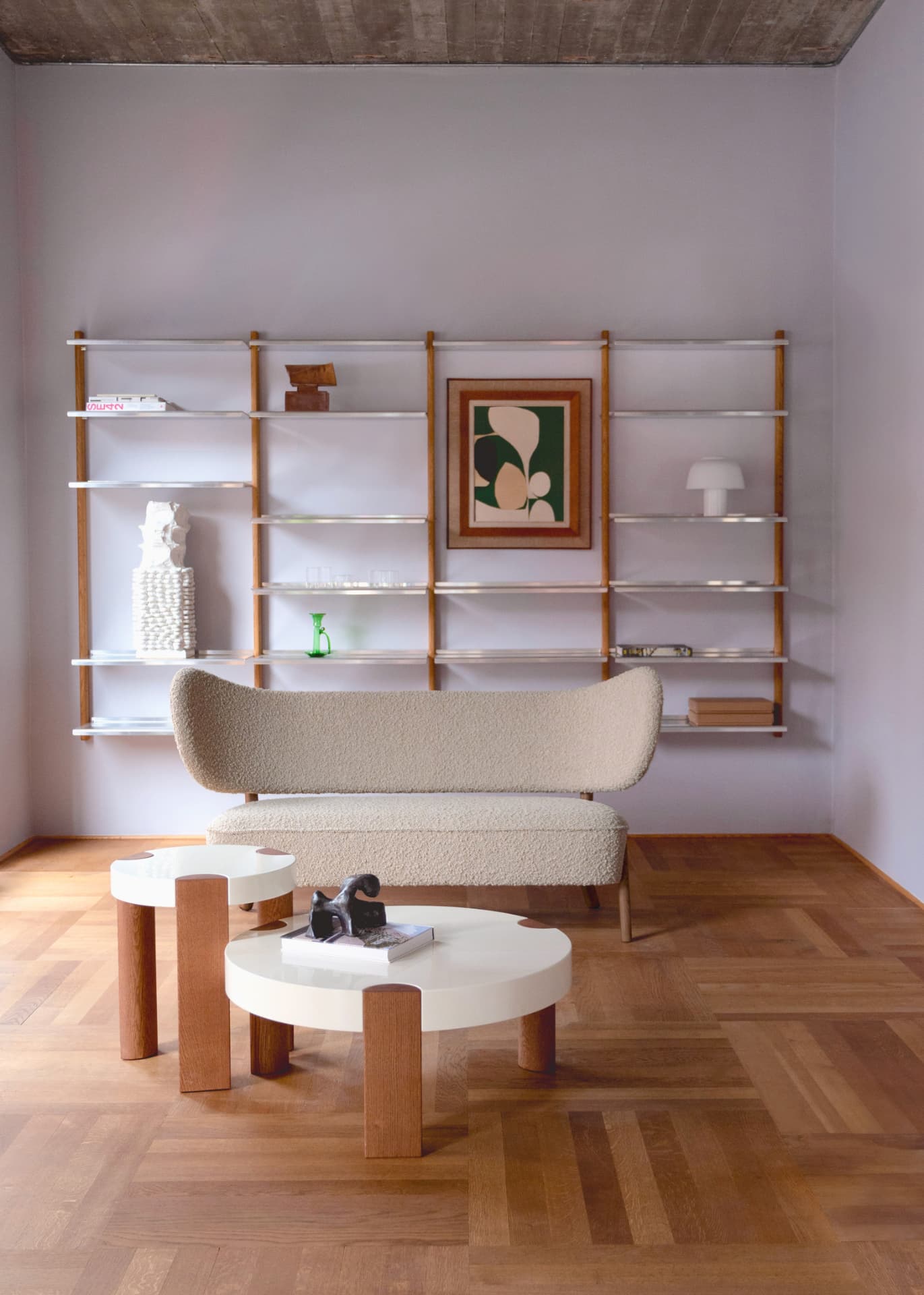 TMBO Sofa in beige bouclé facing a MOD Shelving System with the FER Coffee Table in front